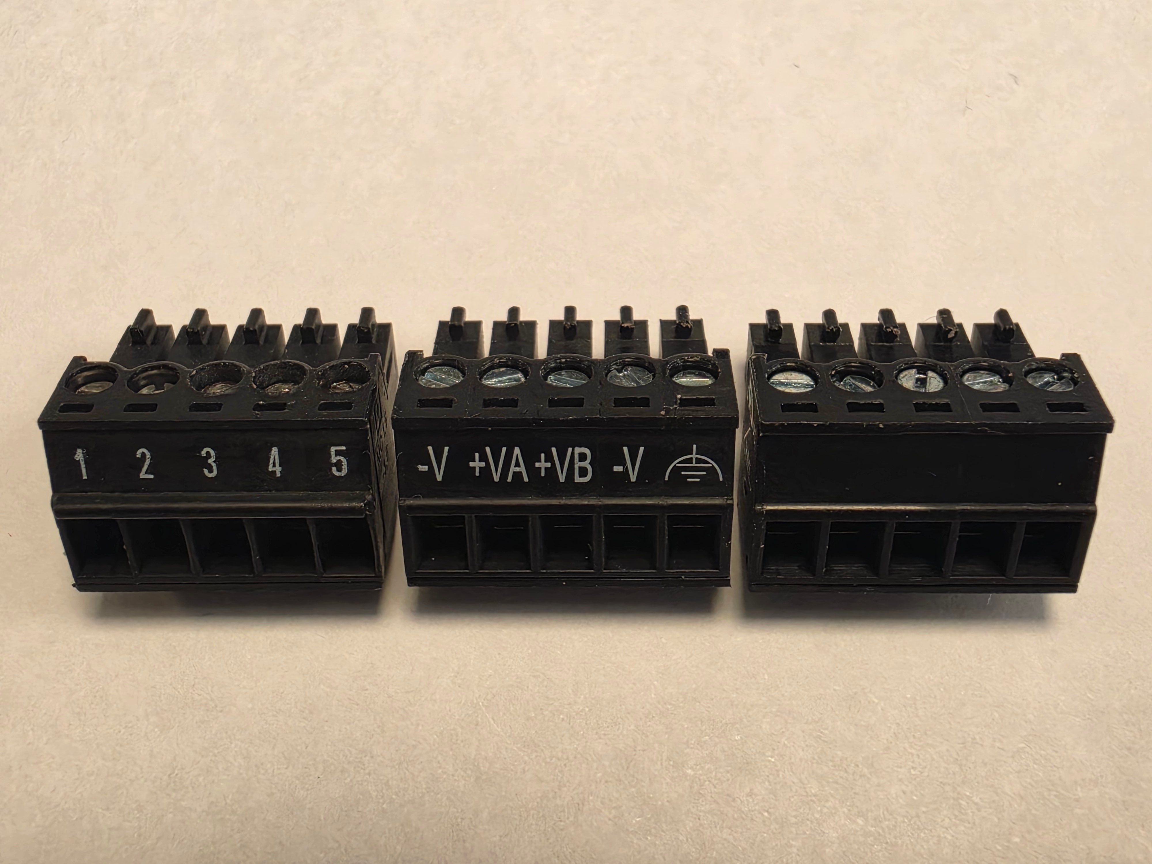The three black terminal blocks showing the different marking they can have.