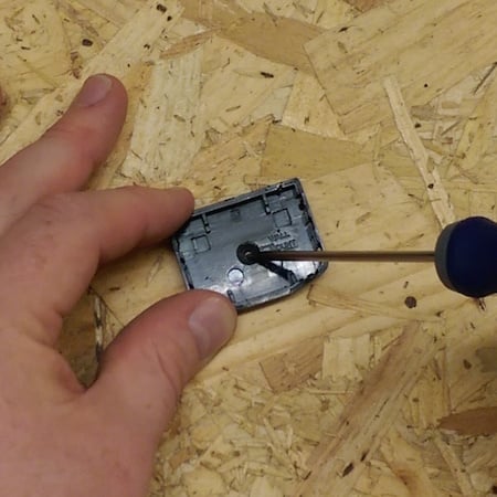 Bradawl pushed through the US-235 case hole to mark the screw position on the wall