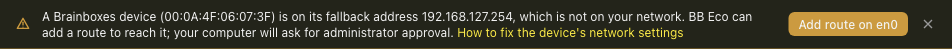 Close-up of the banner: a warning icon, the text 'A Brainboxes device (00:0A:4F:06:07:3F) is on its fallback address 192.168.127.254, which is not on your network. BB Eco can add a route to reach it; your computer will ask for administrator approval.', a link reading How to fix the device's network settings, and the 'Add route on en0' button.