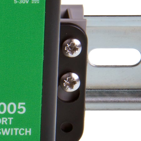 Close-up of crosshead screws securing MK-048 clip to Brainboxes device on DIN rail