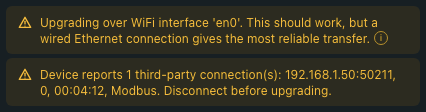 Pre-flight dialog warnings close-up: two amber warning rows side by side. The first reads 'Upgrading over WiFi interface 'en0'. This should work, but a wired Ethernet connection gives the most reliable transfer.' The second reads 'Device reports 1 third-party connection(s): 192.168.1.50:50211, 0, 00:04:12, Modbus. Disconnect before upgrading.'